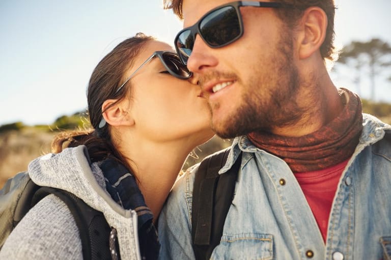 woman kissing man's cheek