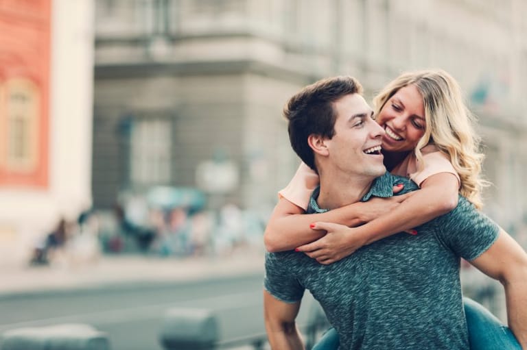 happy couple laughing street