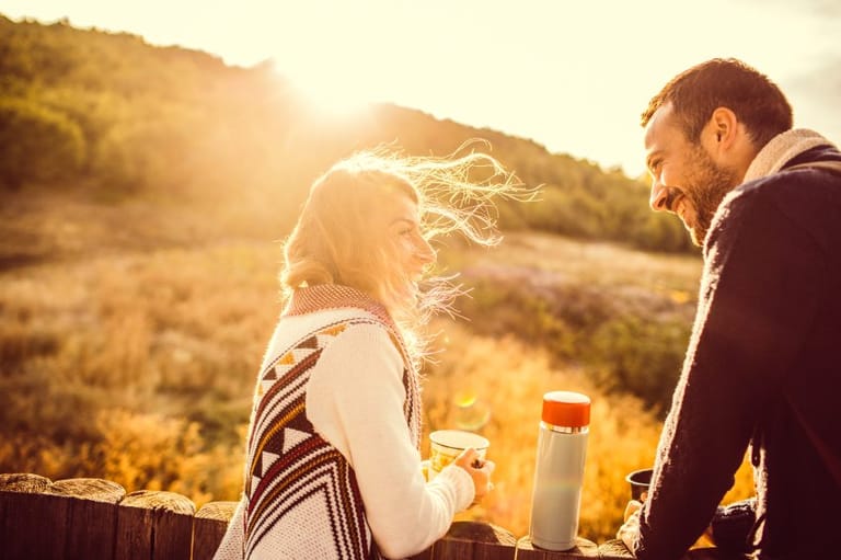 happy couple laughing sunset