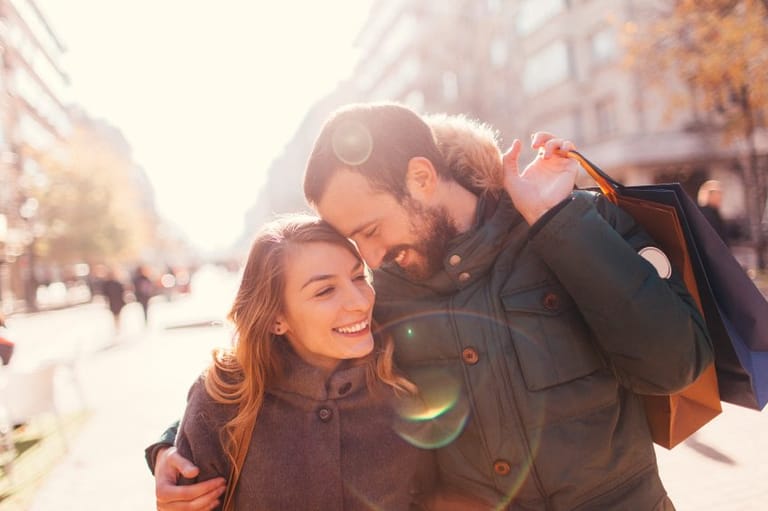 smiling couple walking in winter city