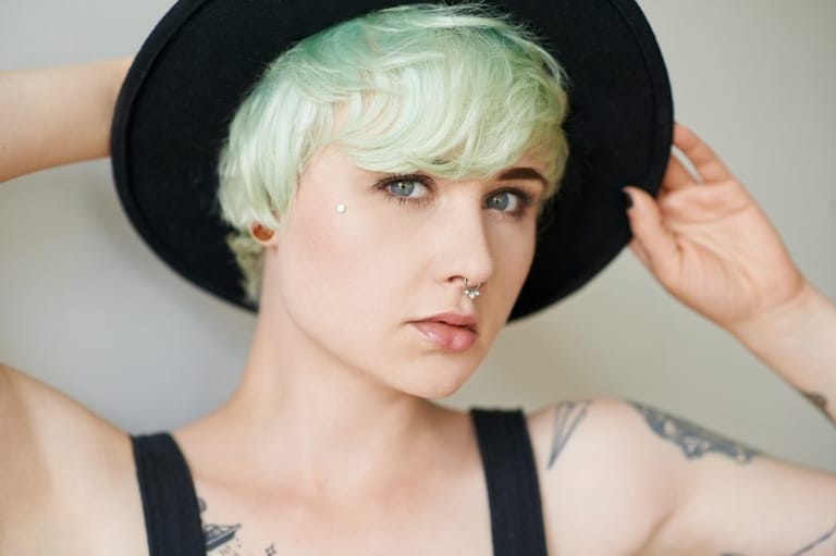 woman green hair tattoo hat