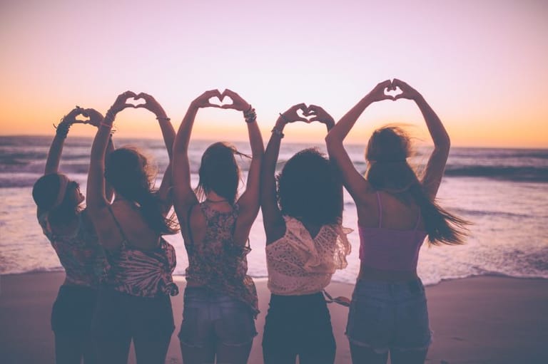 Silhouette of girls making heart shapes