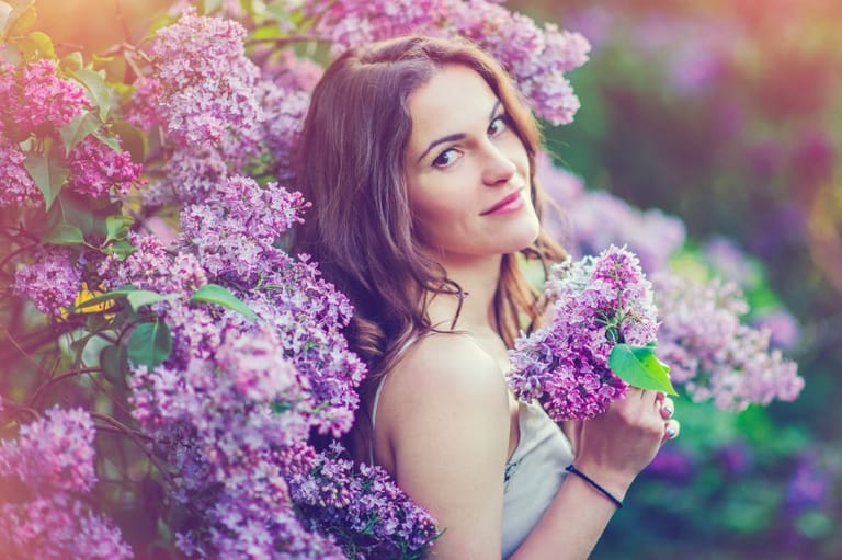 Brunette amongst lilac flowers