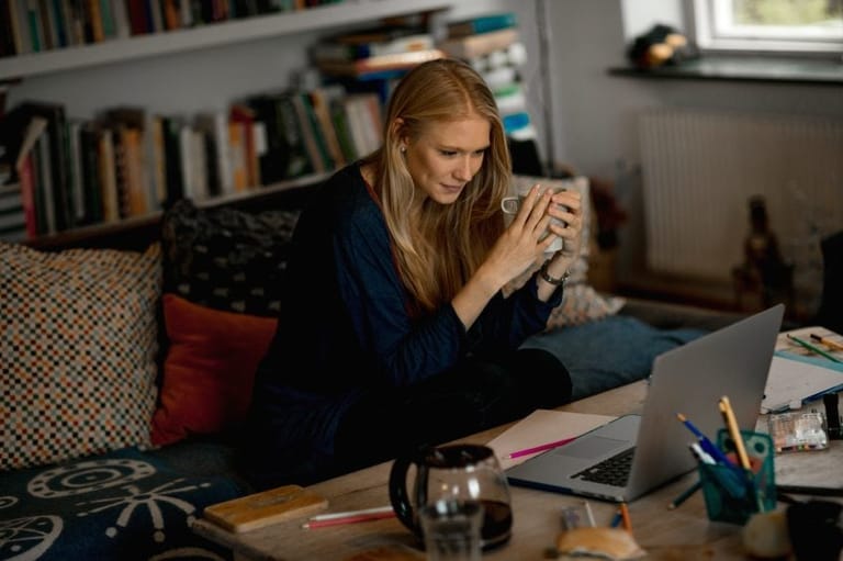 Woman sat looking at laptop