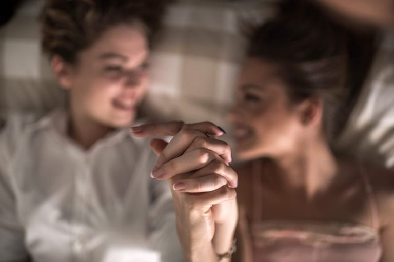 two women holding hands