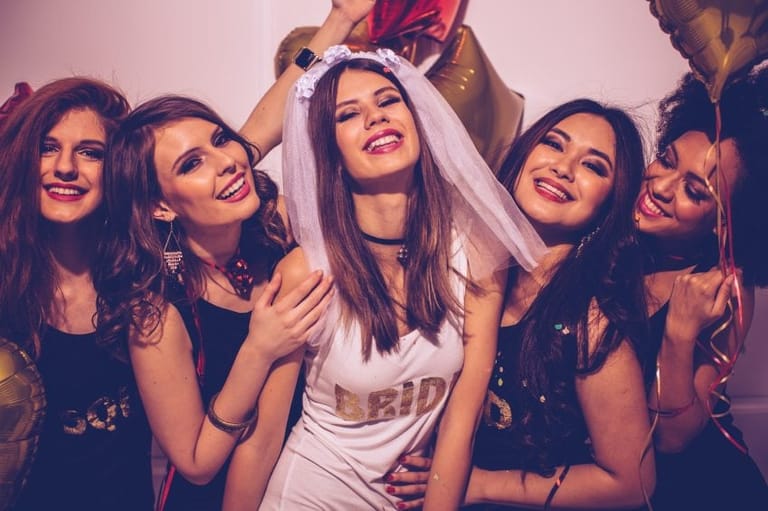 Bride and bridesmaids having fun