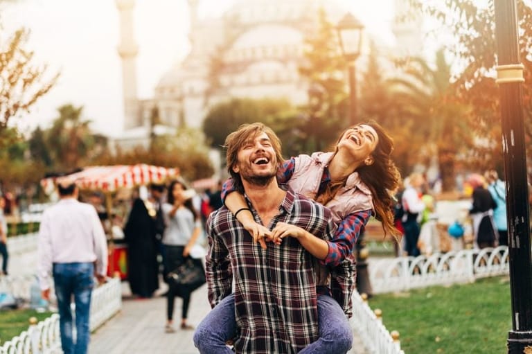 Young couple laughing outside