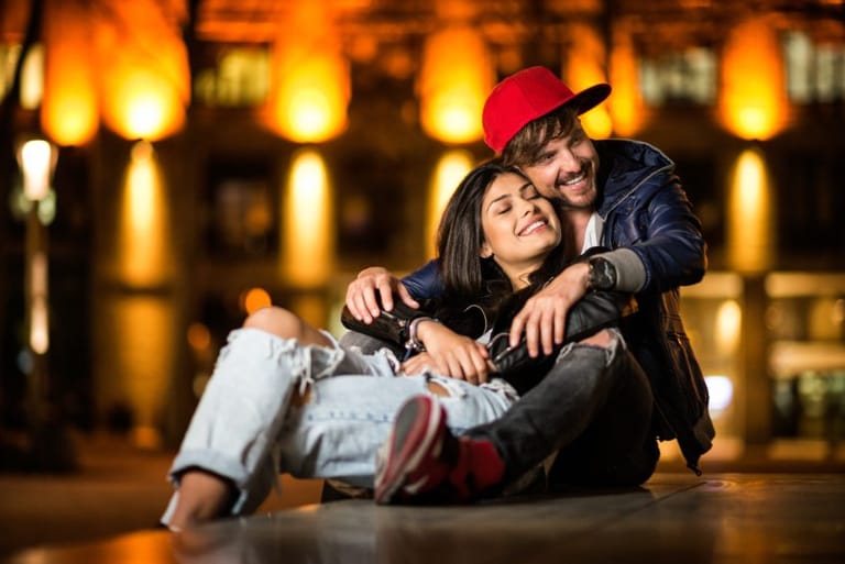 Couple in love on city square at night