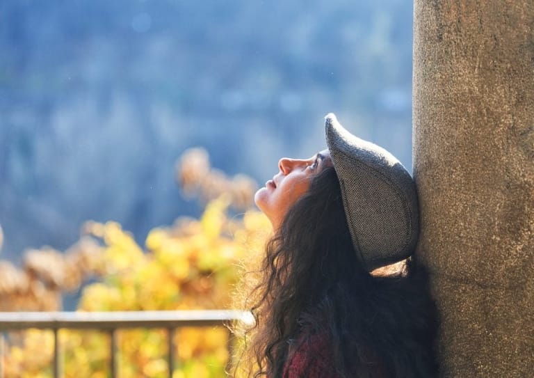 Female leaning against wall