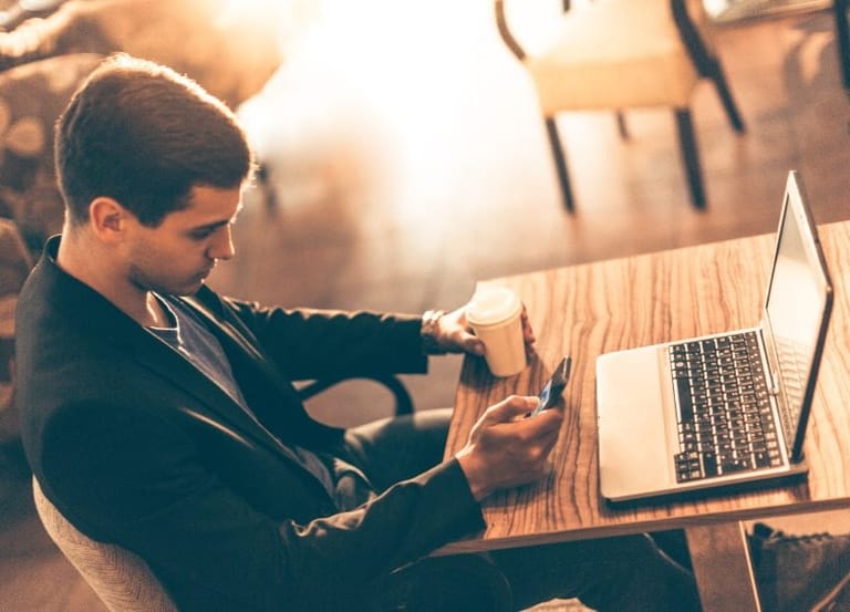 Guy on phone and laptop