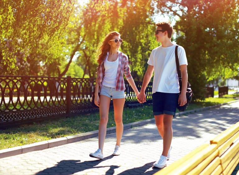 couple holding hands on summer walk