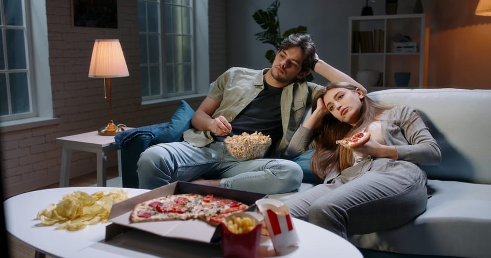 Couple watching TV together.