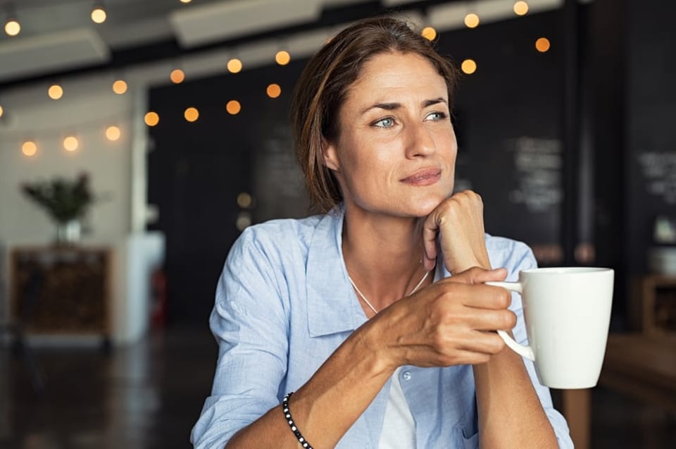 Woman sitting alone having coffee in a cafe.