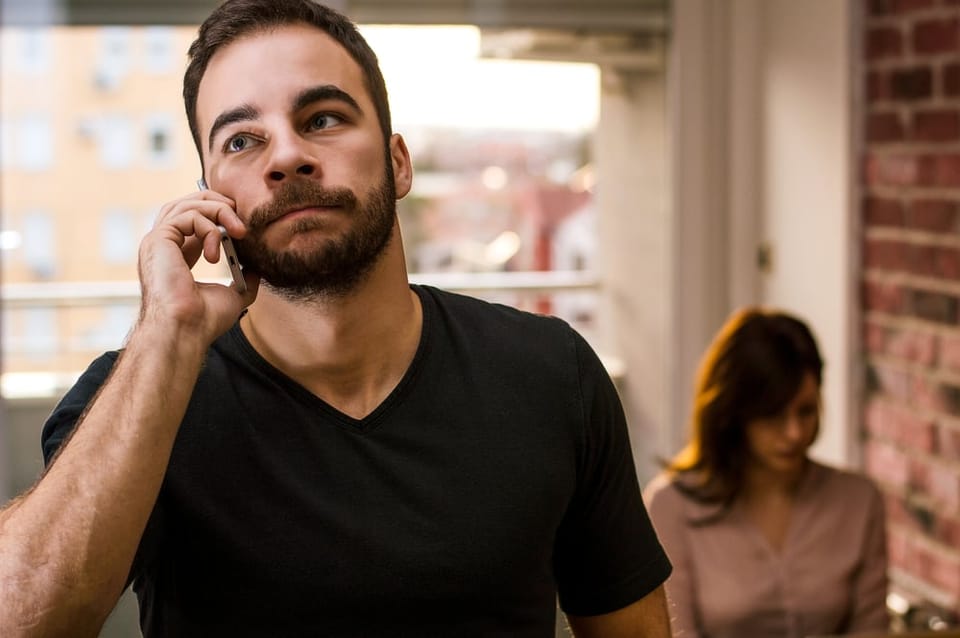 Stressed man speaking on the phone.