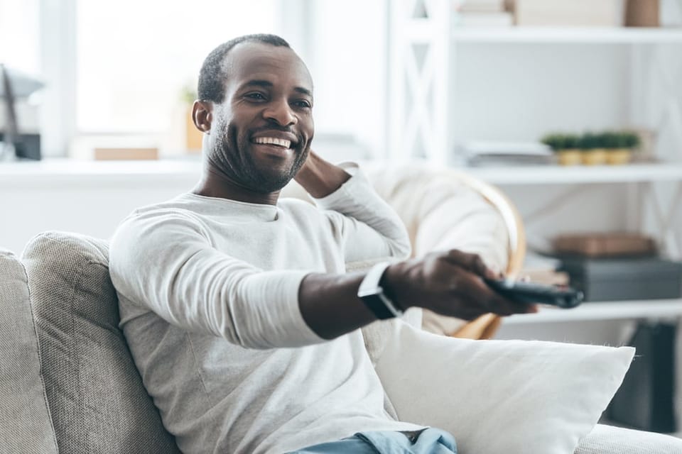 Man using a remote control at home.