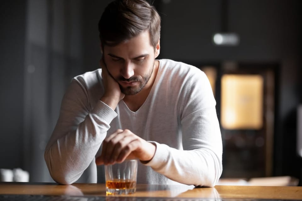 Man having a drink by himself.