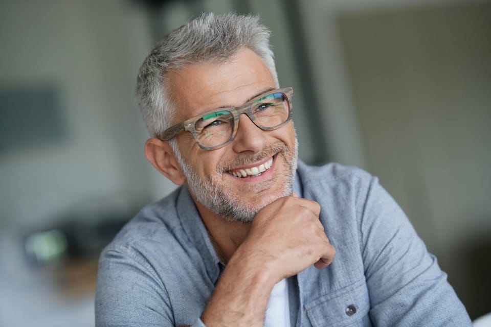 Middle aged man wearing trendy glasses.