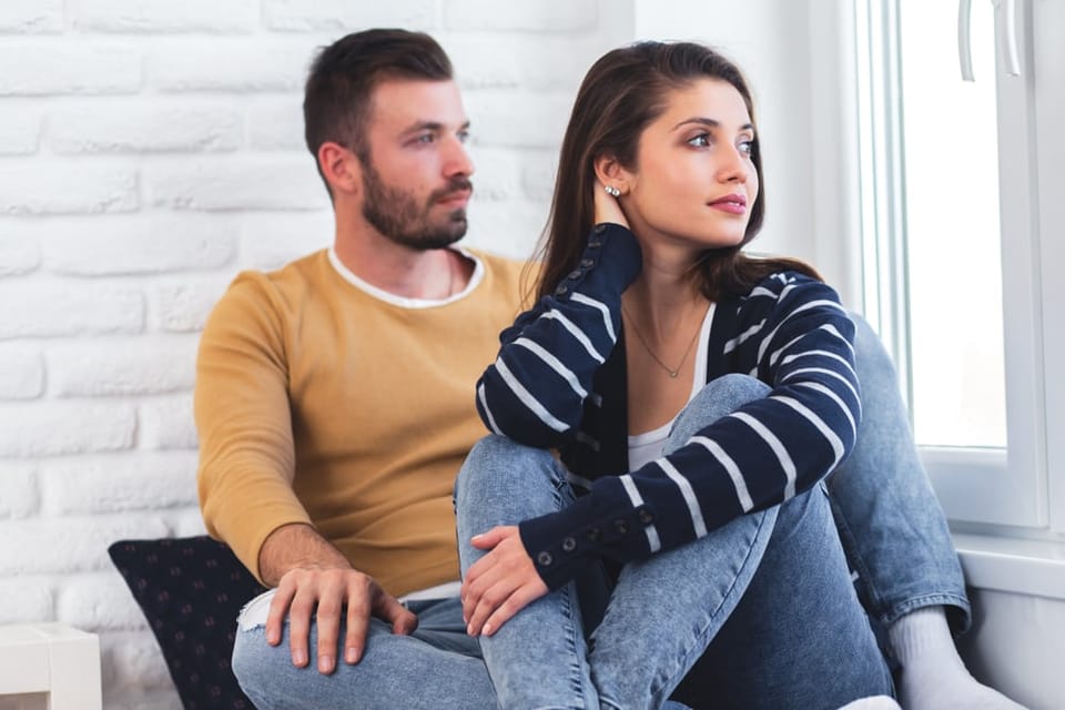 Couple sitting together on the sofa.