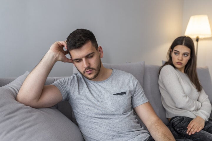 bored guy on couch with girlfriend