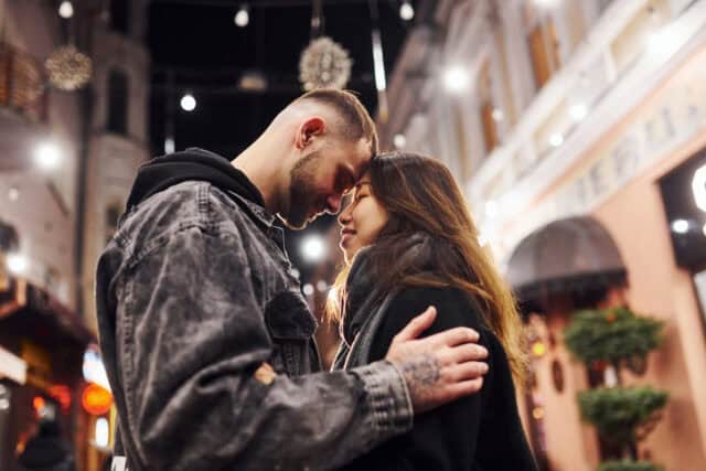 multiracial couple in love city street night