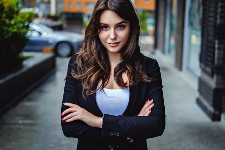 woman with crossed arms on street