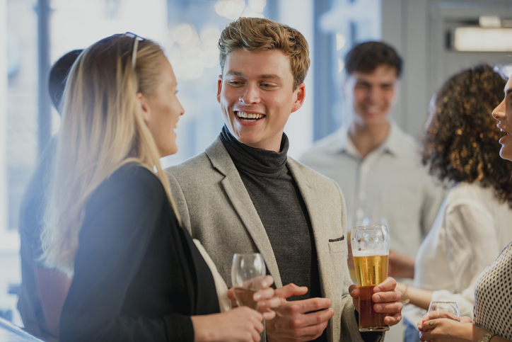 Man talking to a woman at a networking.