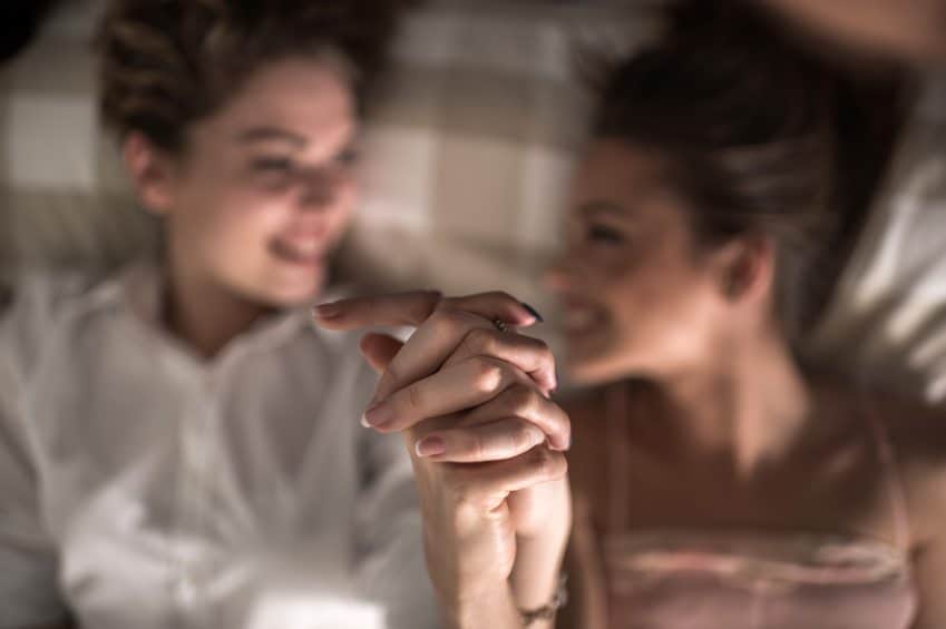 two women holding hands