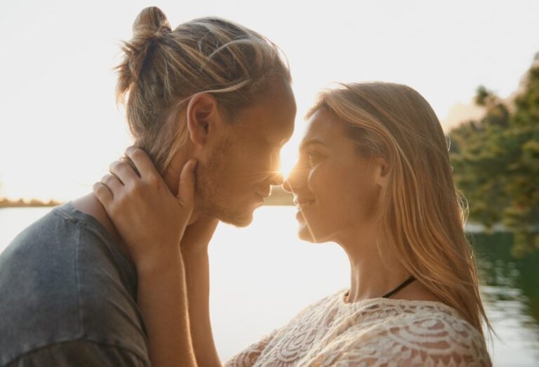 romantic couple embracing by lake