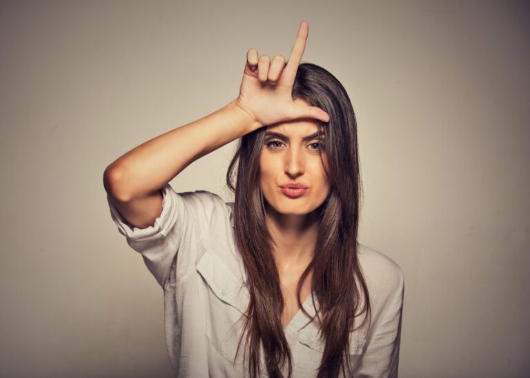 woman doing L sign on forehead