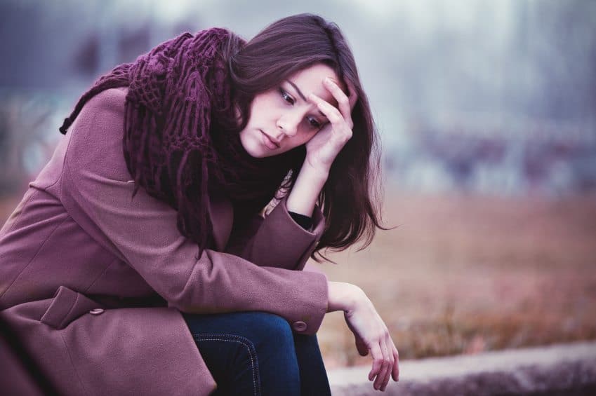 Distraught woman with head in hands
