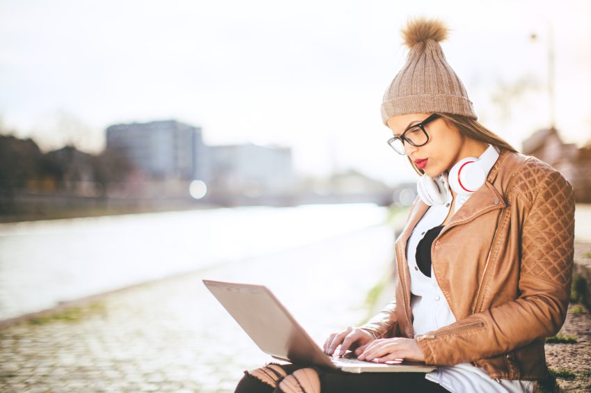 Woman working on laptop in park