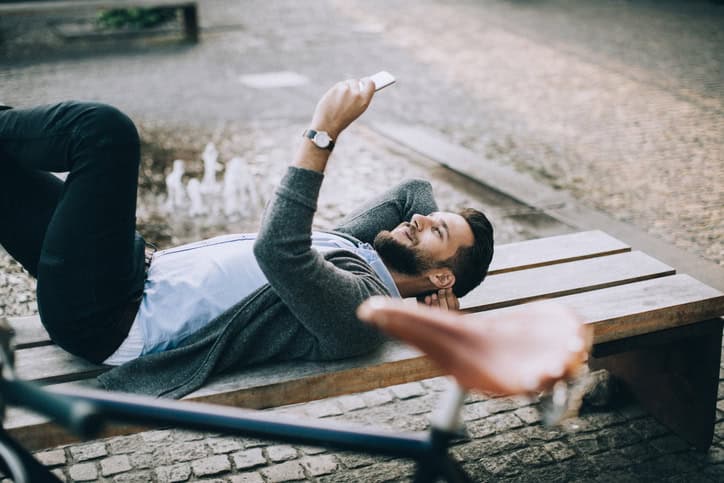 man laying down texting