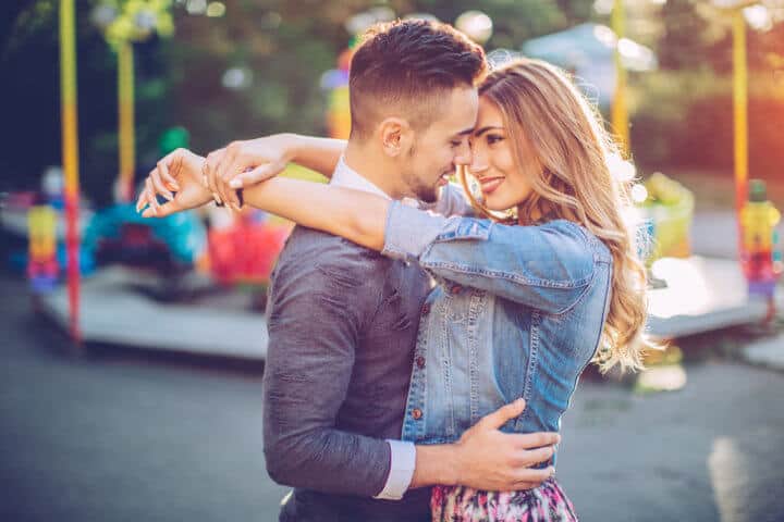 young couple kissing at carnival