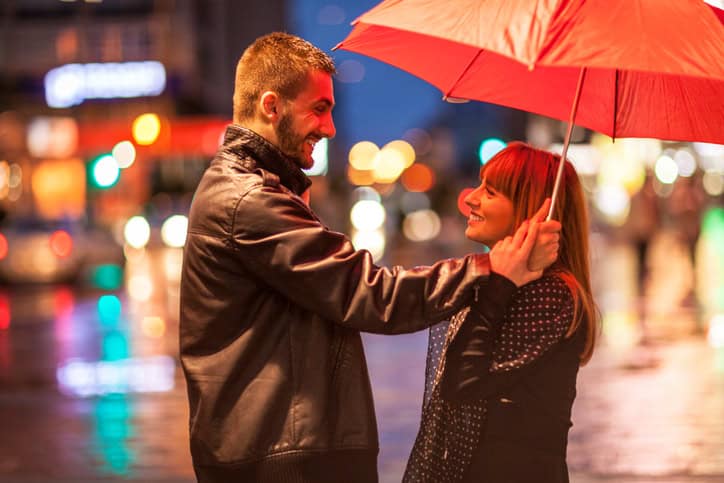 Young couple in the rain