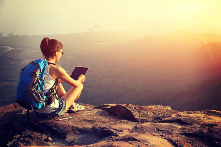 Hiking woman on a mountain peak.