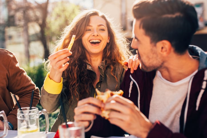 couple laughing at cafe lunch