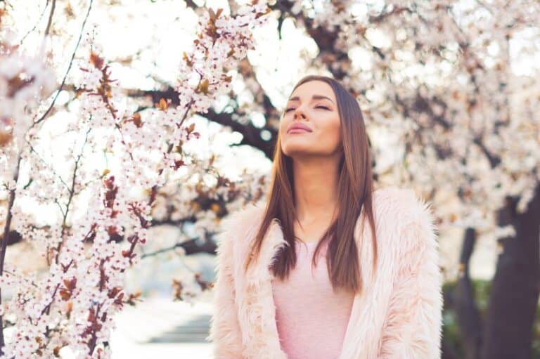 Girl standing under blossom tree