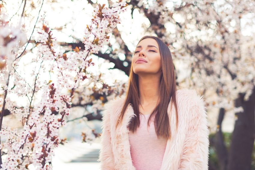 Girl standing under blossom tree