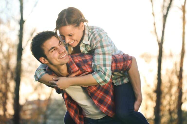 Happy couple giving piggy back