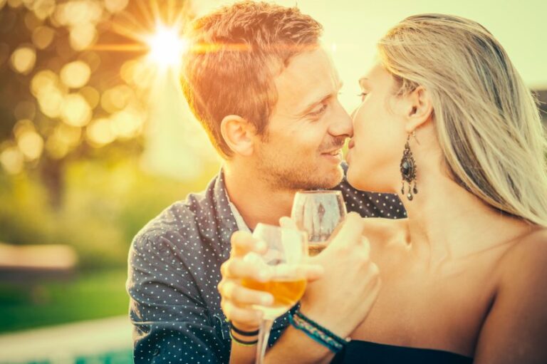 Couple in sunset drinking