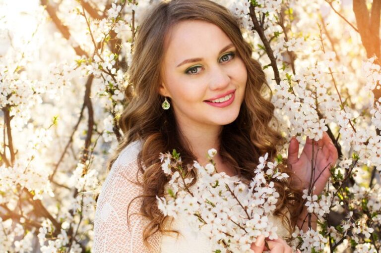 Beautiful girl in blossom cherry garden