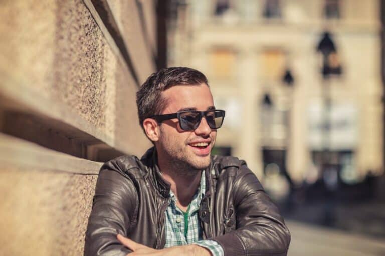 Attractive man sat near a wall