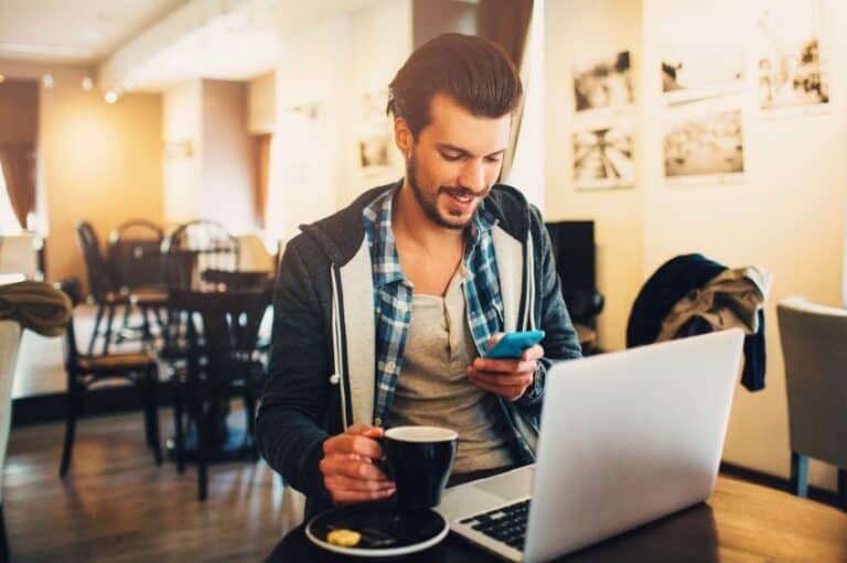 Guy sat with laptop and phone