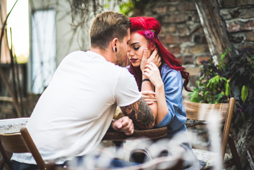 hipster couple holding each other