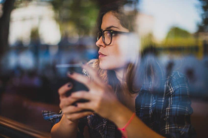 Woman sat in cafe looking out of the window