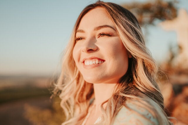 smiling millennial woman portrait sunlight