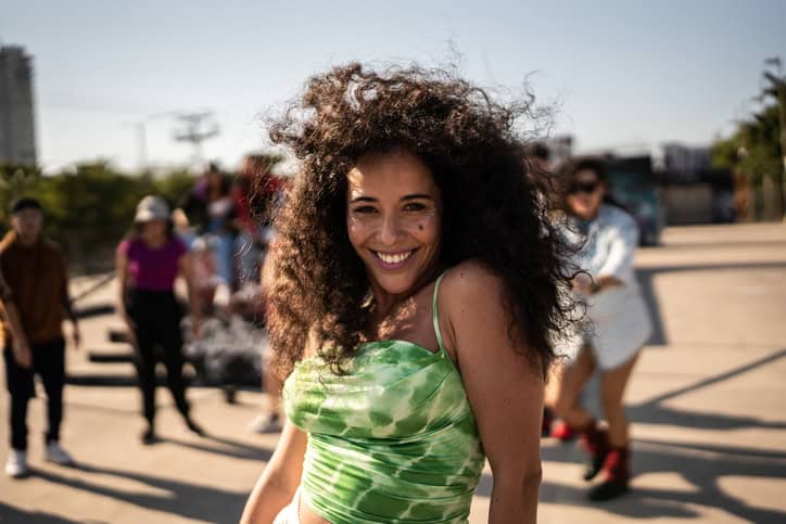 Smiling woman outdoors with friends.