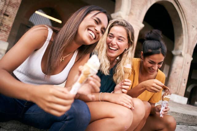happy friends laughing with ice cream