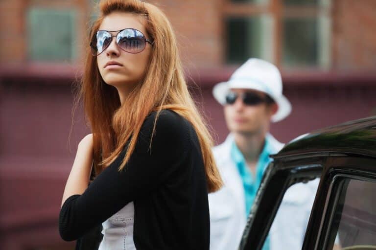 Woman looking sad near car