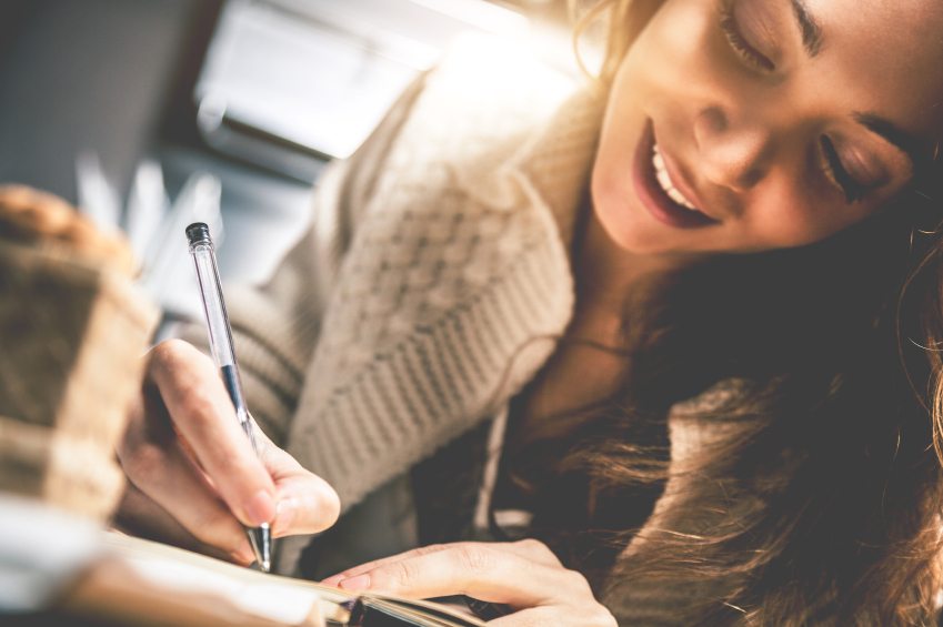 Girl writing in her journal